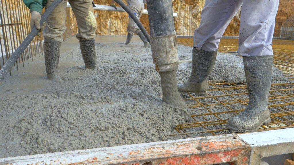 Workers pouring a commercial concrete slab in Boston on a job site
