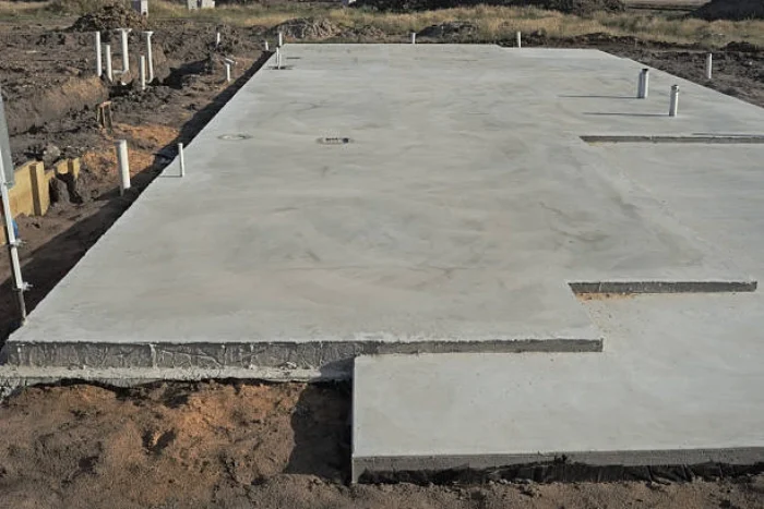 A cross section illustration for understanding concrete slabs, showing reinforcement, sub-base, and vapor barriers essential for quality work by Boston Concrete Work